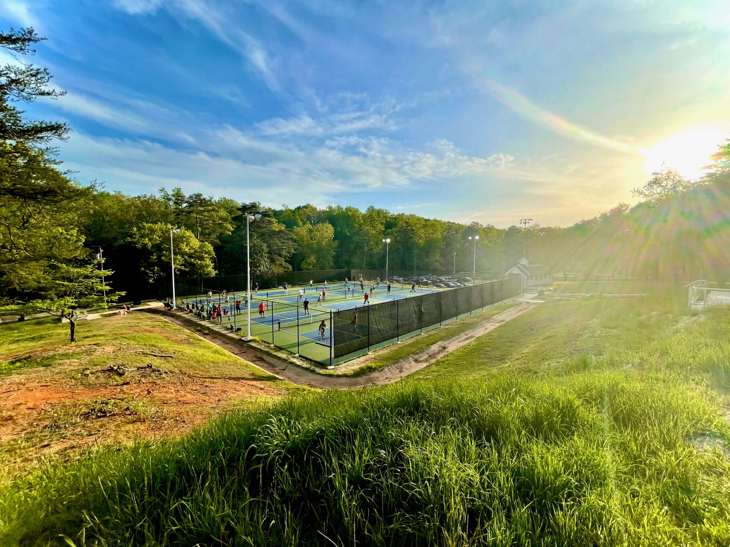 Busy pickleball courts on a sunny early evening at Timmons Park, Greenville, SC.