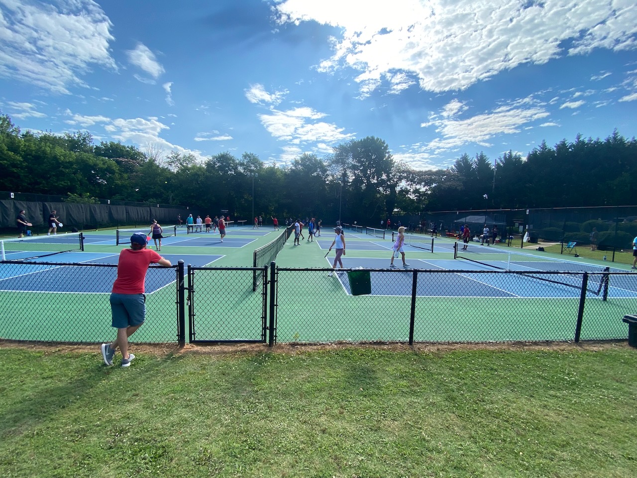 pickleball player watching players play on the courts